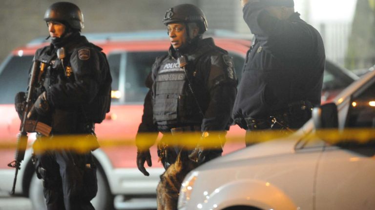 First responders are shown at the scene near the intersection of Myrtle and Tompkins avenues in the Bedford-Stuyvesant neighborhood of Brooklyn where two NYPD officers were shot and killed on Saturday, Dec. 20, 2014.