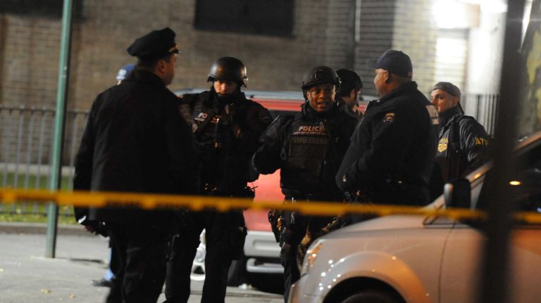First responders are shown at the scene near the intersection of Myrtle and Tompkins avenues in the Bedford-Stuyvesant neighborhood of Brooklyn where two NYPD officers were shot and killed on Saturday, Dec. 20, 2014.