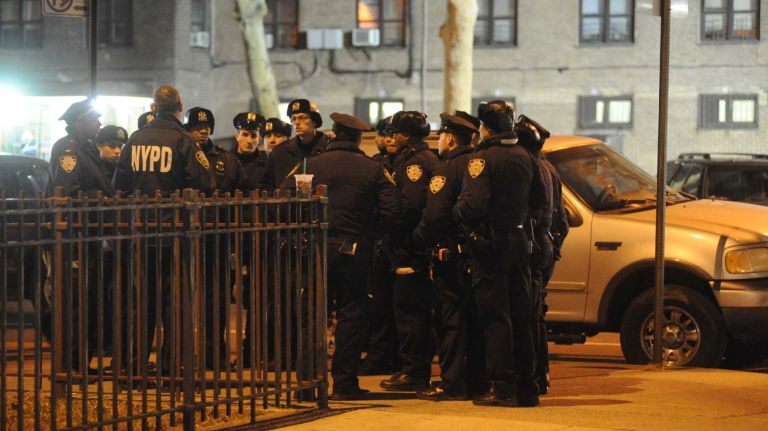 First responders are shown at the scene near the intersection of Myrtle and Tompkins avenues in the Bedford-Stuyvesant neighborhood of Brooklyn where two NYPD officers were shot and killed on Saturday, Dec. 20, 2014.