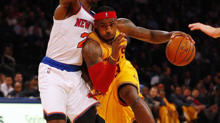 LeBron James of the Cleveland Cavaliers drives to the hoop against Iman Shumpert of the New York Knicks in the second half at Madison Square Garden on Thursday, Dec. 4, 2014.