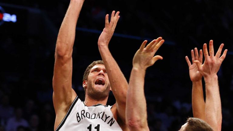 Brook Lopez of the Brooklyn Nets puts up a shot against Aron Baynes of the San Antonio Spurs during an NBA game at Barclays Center on Wednesday, Dec. 3, 2014.