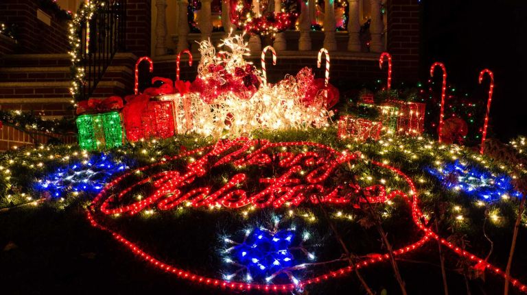 A lawn on Twelfth Avenue in Brooklyn's Dyker Heights wishes bystanders Merry Christmas in lights.