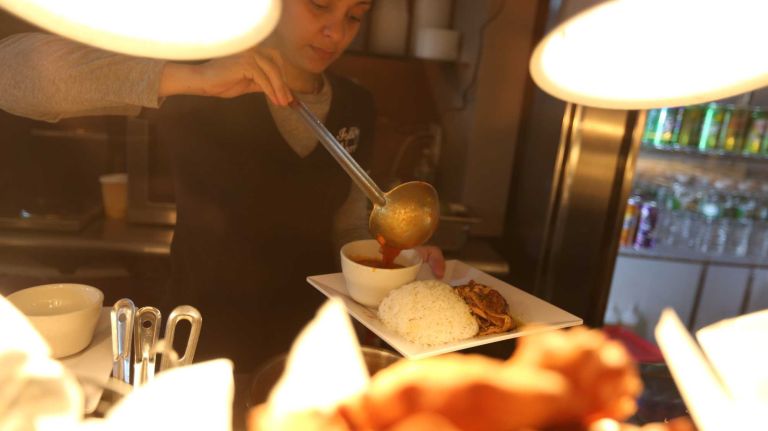Haidy Padilla serves lunch at Isla Verde Cafe at 1959 Westchester ave. in the Soundview section of the Bronx, Thursday, Nov., 20, 2014.