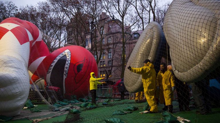 Macy's Thanksgiving Day Parade photos 18 As darkness starts to fall, Macy's Thanksgiving Day Parade balloons are prepared and inflated by the Natural History Museum near the parade route Wednesday, Nov. 26, 2014, in preparation for the decades old tradition of the Thanksgiving Day parade Thursday.