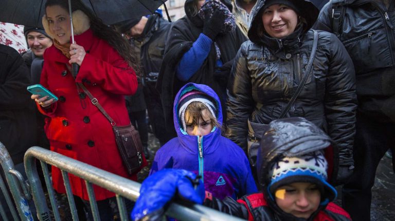 Macy's Thanksgiving Day Parade photos 20 Children and adults alike take cover from the elements as they watch Macy's Thanksgiving Day Parade balloons as they are prepared and inflated by the Natural History Museum near the parade route Wednesday, Nov. 26, 2014, in preparation for the decades old tradition of the Thanksgiving Day parade Thursday.