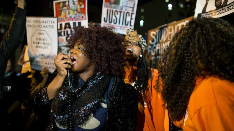 People gather at Union Square in Manhattan Monday, Nov. 24, 2014, as they await for word if a grand jury will recommend charges against Ferguson officer Darren Wilson who shot and killed an unarmed Michael Brown in August, sparking violent protests in Ferguson, Mo.
