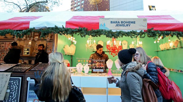 Yassel Iglesias from Manhattan works the Bara Boheme Jewelry booth at the Union Square Holiday Market, Friday, Nov. 21, 2014.