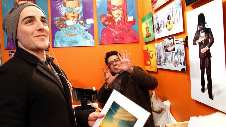 From left, Keaton Williams from Manhattan chats with Marcos Minuchin from Long Beach, working at The Secret Life of Toys booth at the Union Square Holiday Market, Friday, Nov. 21, 2014.