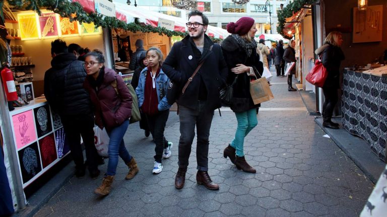 Shoppers browse the Union Square Holiday Market, Friday, Nov. 21, 2014.
