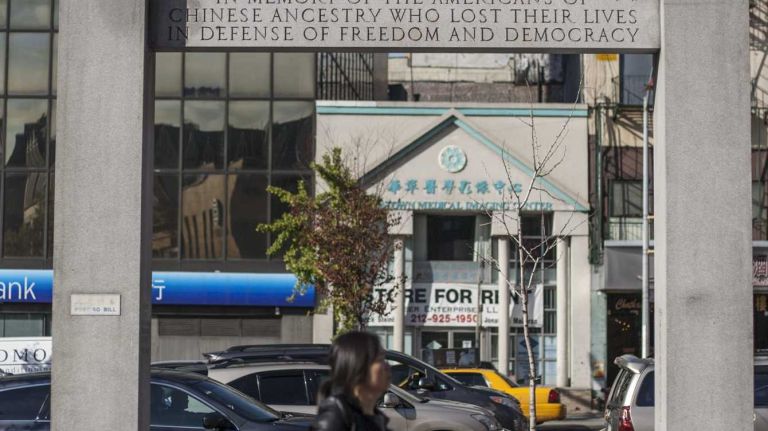 A woman walks through Chatham Square in Chinatown in Manhattan, on Nov. 4, 2014.
