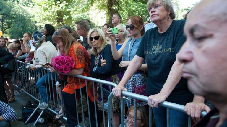 Crowds of Joan Rivers fans line the streets near Temple Emanu-El in Manhattan before a private funeral for Joan Rivers on Sunday, Sept. 7, 2014.