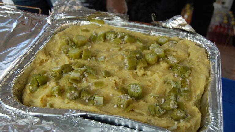 Cou-cou is a mixture of cornmeal, okra and spices. It is typically eaten with fried fish and gravy. 