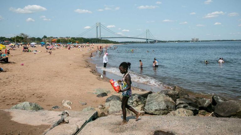 People on the beach near the Verrazano Bridge.