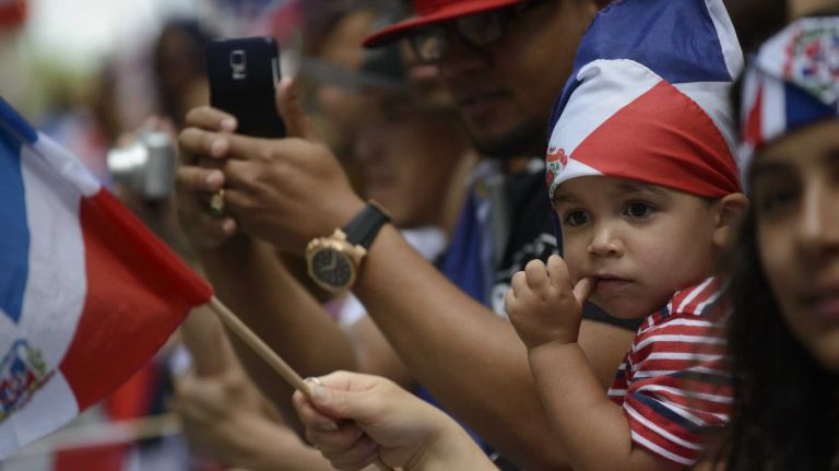 Angel Caballero, 2, of Connecticut, watches the 33rd annual Dominican Day Parade on Sixth Avenue in Manhattan on Sunday, Aug. 10, 2014.