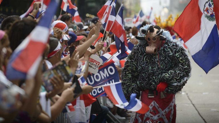 Participants march and dance in the 33rd annual Dominican Day Parade on Sixth Avenue in Manhattan Sunday, Aug. 10, 2014.