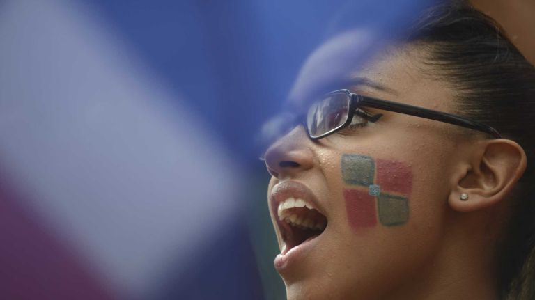 Nicole Rosado, of Westchester, cheers as participants march and dance in the 33rd annual Dominican Day Parade on Sixth Avenue in Manhattan, Aug. 10, 2014.