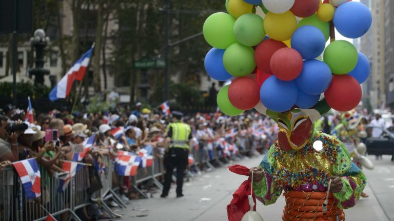 Participants march and dance in the 33rd annual Dominican Day Parade as thousands of spectators line Sixth Avenue in Manhattan to celebrate their heritage on Aug. 10, 2014.