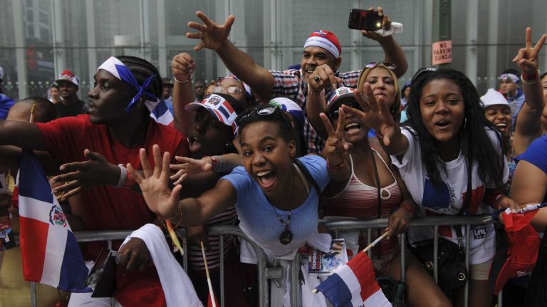Thousands of spectators cheer during the 33rd annual Dominican Day Parade on Sixth Avenue in Manhattan on Sunday, Aug. 10, 2014. 