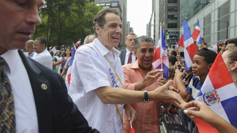 Governor Andrew M. Cuomo shakes hands with spectators during the 33rd annual Dominican Day Parade in Manhattan on Sunday, Aug. 10, 2014.