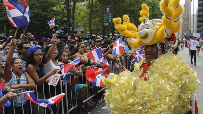 Participants march and dance in the 33rd annual Dominican Day Parade on Sixth Avenue in Manhattan on Sunday, Aug. 10, 2014.