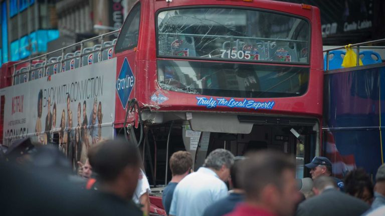 A damaged tour bus is seen after two double-decker buses collided near Times Square, at West 47th Street and Seventh Avenue, on Tuesday, Aug. 5, 2014. At least 14 people were injured, according to the FDNY and NYPD.