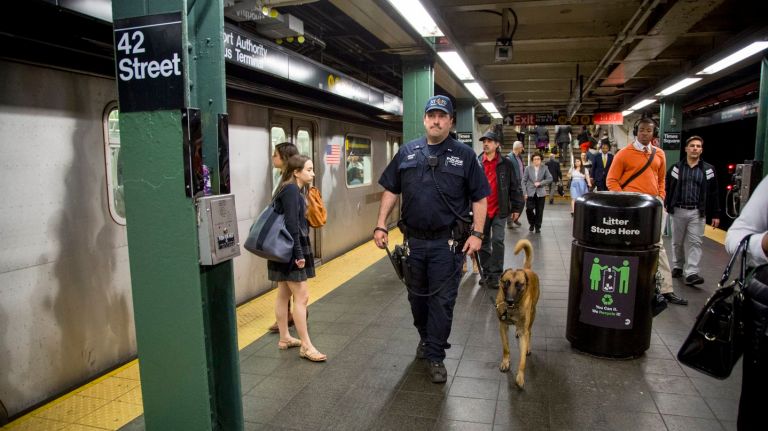 NYPD Officer Thomas Regnier and his canine  partner Mikey patrol  the Times Square subway station on May 16, 2017.