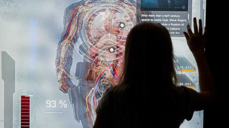 Marvel's Avengers S.T.A.T.I.O.N. exhibit 15 A visitor looks over the Captain America exhibit on view at the exhibit of