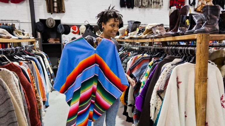 “Eventually, I want to only buy thrifted clothes because there’s so much waste in the world,” says Chiara, who checked out the store’s colorful ponchos. 