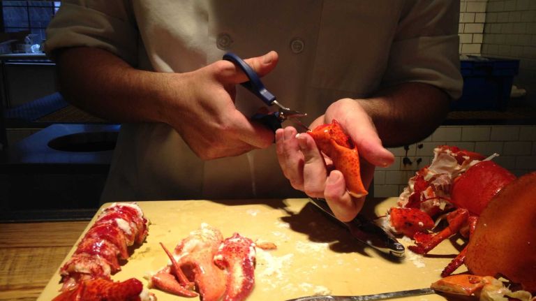 Next, break open the knuckles using a pair of small scissors, like herb clippers, or a knife, by making four cuts around the shell to remove the meat.