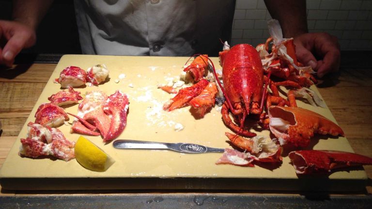 Congrats, you're done! Now you can enjoy the tail, claw and knuckle meat with some lemon and butter. If you so desire, you can also break open the legs and suck the meat out. Also, don't be alarmed by the green gook at the end of the tail meat (the lobster's liver and pancreas). It's totally edible, but you can wash or cut this off if you can't, um, stomach it.