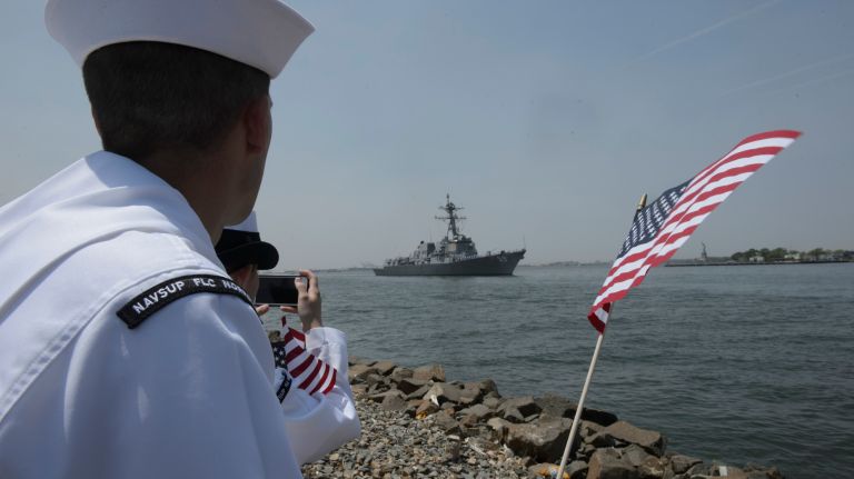 Navy sailors watch from Red Hook, Brooklyn, as the USS Farragut sails into New York Harbor for Fleet Week on May 25, 2016.