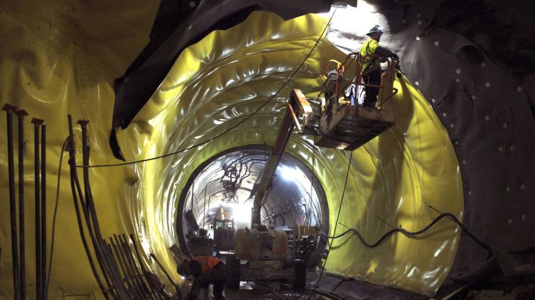 Workers install waterproofing material in the west tunnel at the 86th Street cavern of the Second Avenue Subway line on Thursday, May 01, 2014. As of April 01, 2014, 65.6% of construction of Phase 1 of the Second Avenue Subway is complete.