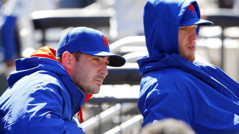 Matt Harvey, left, and Zack Wheeler look on from the dugout during a game against the Washington Nationals at Citi Field on Monday, March 31, 2014.