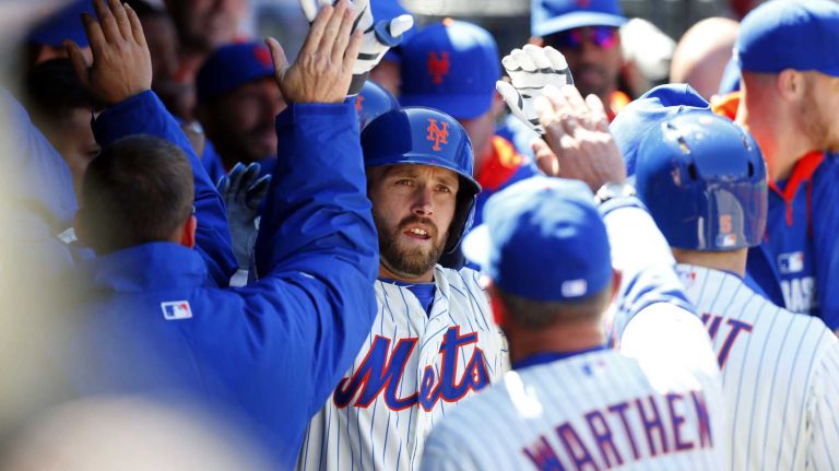 Andrew Brown celebrates his three-run home run in the dugout with his teammates in the first inning of a game against the Washington Nationals at Citi Field on Monday, March 31, 2014.