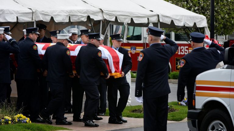 Firefighters carry the coffin containing the body of FDNY firefighter William Tolley, who died in the line of duty while battling a fire in Queens on April 20th, from Chapey and Son's Funeral Home in Bethpage on Thursday, April 27, 2017.