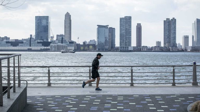 A man run along the Hudson River Greenway in TriBeCa in Manhattan on March 20, 2014. 