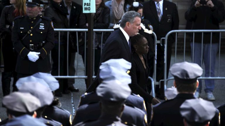 NYPD Officer Dennis Guerra remembered at memorial, funeral 28 Mayor Bill de Blasio and his wife, Chirlane McCray, arrive at the funeral for fallen NYPD Officer Dennis Guerra is carried into St. Rose of Lima Roman Catholic Church on Monday, April 14, 2014. Guerra, 38, died early April 9 of smoke inhalation and carbon monoxide poisoning after he and fellow officer Rosa Rodriguez were overcome by dense smoke and toxic fumes in a Coney Island high-rise fire on April 6.