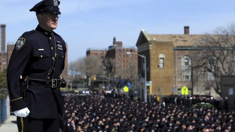 NYPD Officer Dennis Guerra remembered at memorial, funeral 31 Police officers stand at attention as the coffin holding the body of fallen NYPD Officer Dennis Guerra is carried into St. Rose of Lima Roman Catholic Church on Monday, April 14, 2014. Guerra, 38, died early April 9 of smoke inhalation and carbon monoxide poisoning.