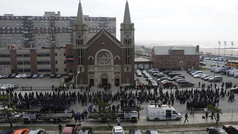 NYPD Officer Dennis Guerra remembered at memorial, funeral 39 Police arrive to pay their respects before a funeral Mass at St. Rose of Lima Church April 14, 2014, in Far Rockaway for NYPD Officer Dennis Guerra who died of smoke inhalation on April 9 after responding to a fire at a Coney Island high-rise on April 6.
