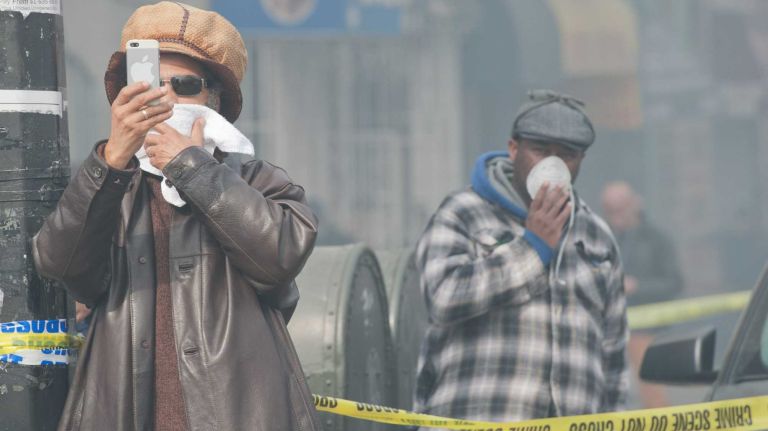 East Harlem explosion 10 Residents watch as emergency personnel respond to the scene of an explosion and building collapse in East Harlem on Wednesday, March 12, 2014.