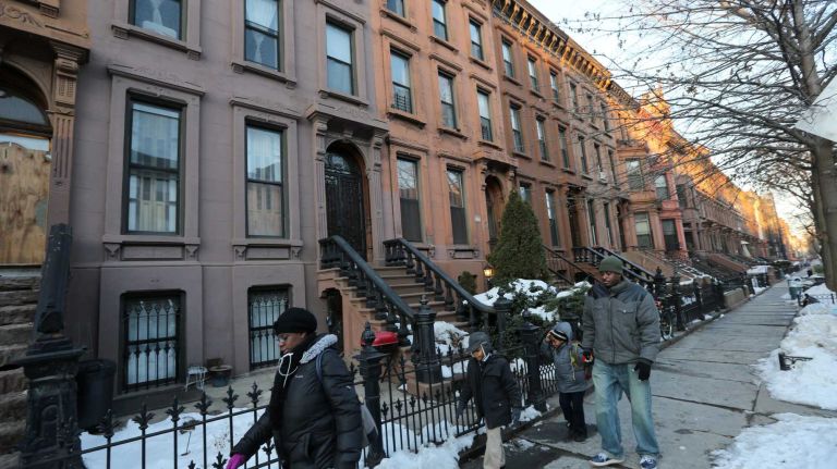 Walking along Hancock Street between Nostrand and Marcy.