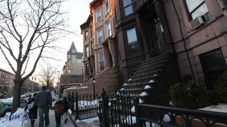 Walking along Hancock Street between Nostrand and Marcy. 