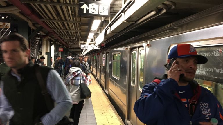 The 7 line was suspended along its entire route for about an hour during Wednesday evening's commute due to signal problems, the MTA said. Above, passengers wait at the 7 train platform in Times Square on April 19, 2017.
