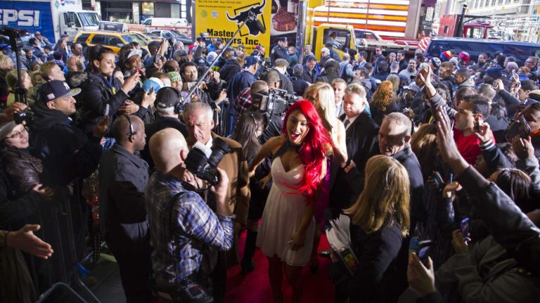 WWE star Eva Marie, center, arrives at the Hard Rock Cafe in Manhattan Tuesday, April 1, 2014, as they kick off Wrestlemania 30 week. 