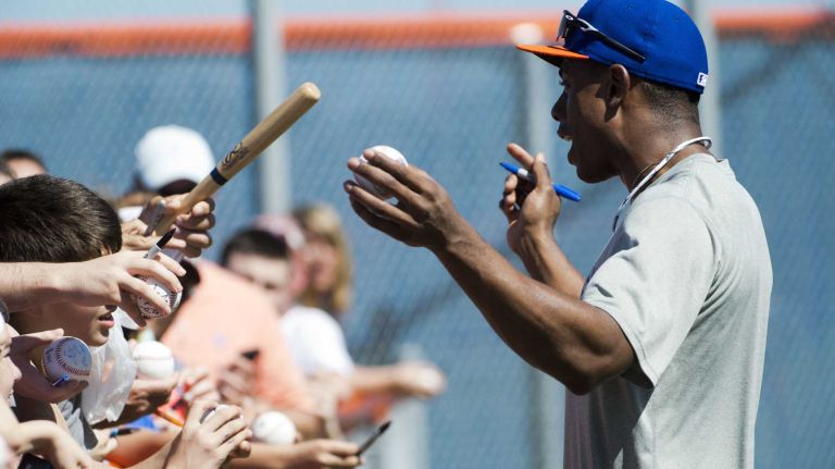 Mets outfielder Curtis Granderson signs autographs during spring training on Tuesday Feb. 18, 2014, in Port St. Lucie, Fla.