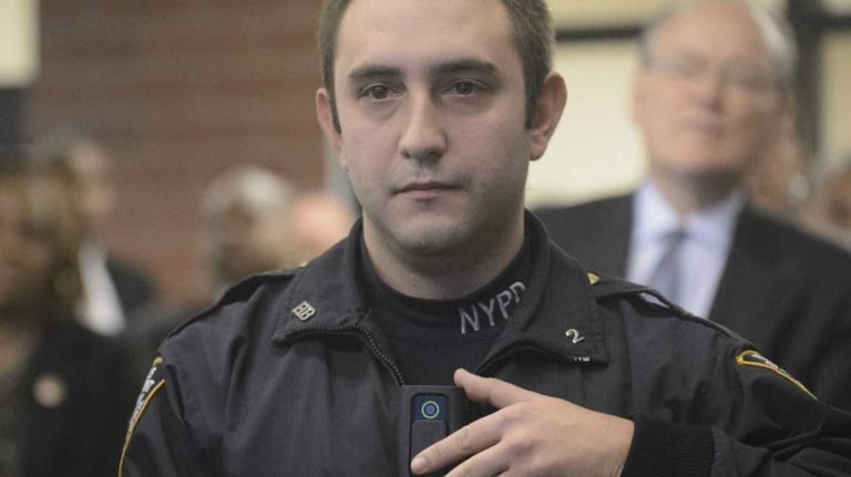A New York City Police Department police officer activates a VIEVU body worn camera during a demonstration at the new police academy building in Queens on Wednesday, Dec. 3, 2014.