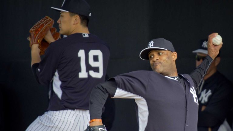 Yankees' Masahiro Tanaka, left, and CC Sabathia work out in the bullpen at Steinbrenner Field on the morning of Feb. 15, 2014.