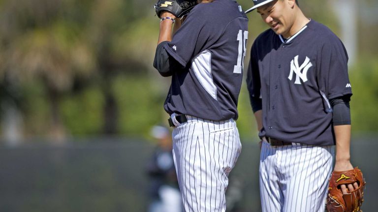 Yankees' Hiroki Kuroda and Masahiro Tanaka work out at Steinbrenner Field in Tampa, Fla. on the morning of Feb. 15, 2014.