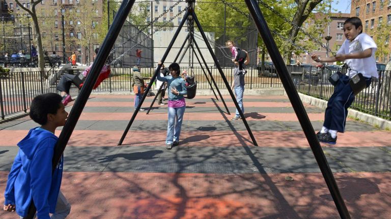 Kids have fun on the swings at Thomas P. Noonan Jr. Park. 