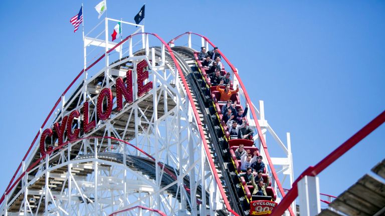 People ride the Cyclone during the opening weekend of Luna Park and The Cyclone roller coaster in Coney Island on Apr. 9, 2017.